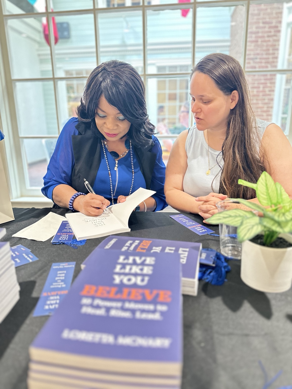 Signing a copy at a reader event