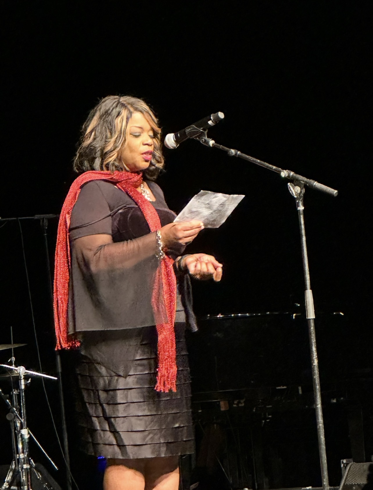 Loretta McNary delivering a keynote in an evening gown